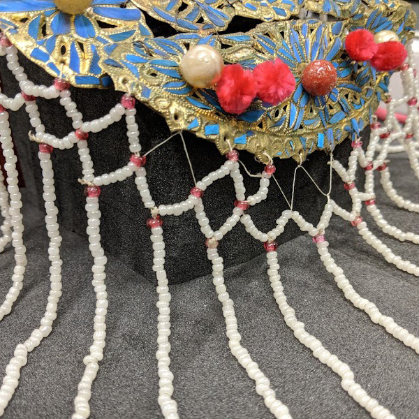 Stabilized beads on Chinese headdress